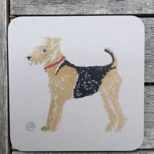 This animal coaster shows an airedale dog in tan and black, with a red collar, set against a warm grey background and goes well with our A for airedale under acorns or A for Admiral Airdale , placemats. Made of board coated in melamine and backed in cork. heat resistant.