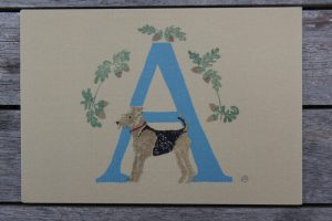 illustrated alphabet letters make great cards! this is of blue letter A illustrated with branches of acorns and an airedale dog, on a beige background