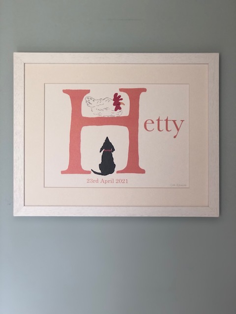 A large coral coloured H initial with the Name Hetty added. is illustrated with a happy hen, happy because he is out of reach of the hound, a black dog, sitting under the bar of the H on which the hen sits. Hetty's birthday date also has been added below the H. A perfect gift for Hetty's bedroom.