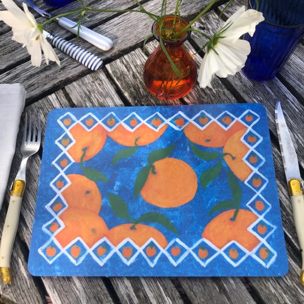 placemat of decorative seville oranges on a blue background
