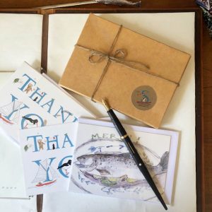 a recyclable cardboard box tied with twine which you can use in the garden, will hold 2 sets of correspondence cards - of different designs