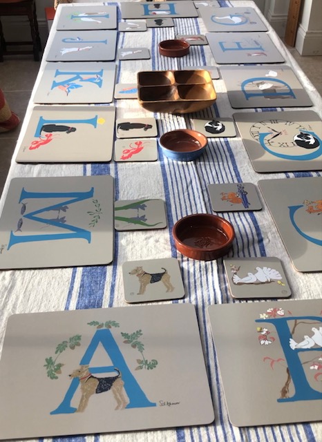 illustrated alphabet letters on melamine and cork backed place mats make a jolly setting for a friendly gathering with each person's initial indicating where they should sit!