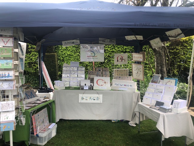 from Sal trade stall at the WINCHESTER GOLD garden fair in May 23. showing all my products laid out on tables within a small tent. 