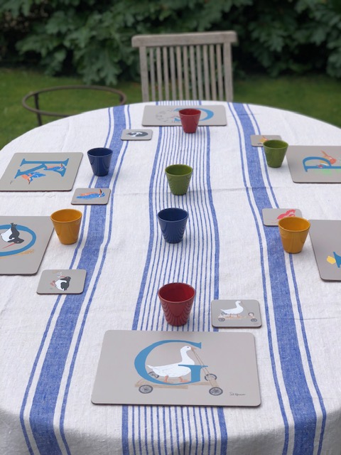 This image is all about colour, to show how our illustrated placemats ring with the saturated colours of the mediterranean: chrome yellow , favoured by Van Gogh; earth green, vermillion reds as found in Pompeii and the blue of the mediterranean sea, cerulean, and sky, cobalt. Set on a background of bleached linen, our placemats look good in a neutral setting or a colourful setting.