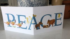 A Christmas card decorated with the word PEACE amongst the letters are the Nativity figures.